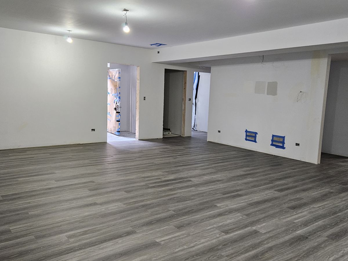 After: Bare basement to vinyl plank