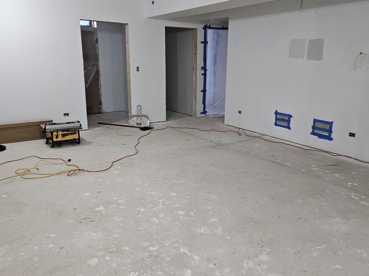 Before: Bare basement to vinyl plank